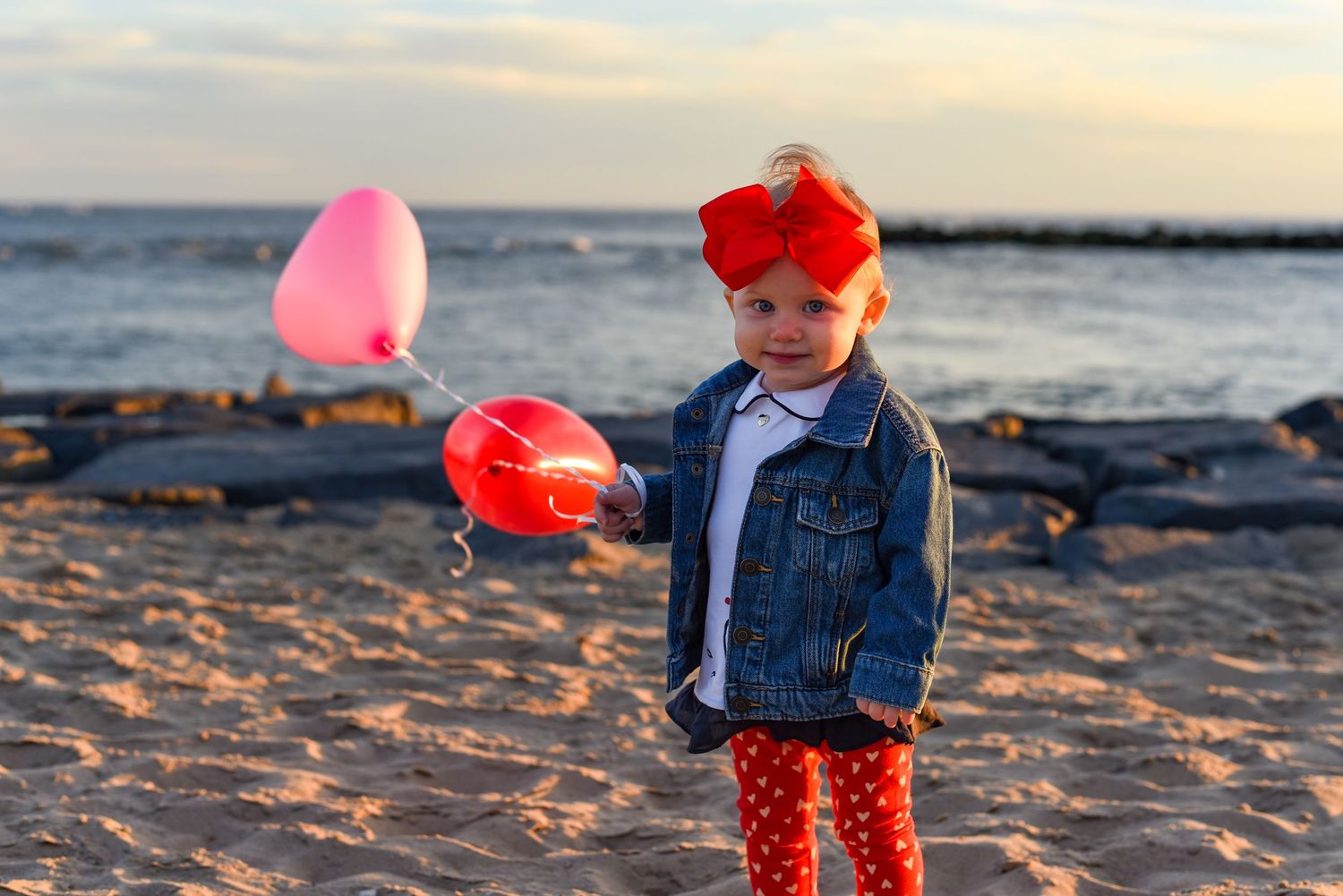 Ocean city beach photo of a child holding balloons,