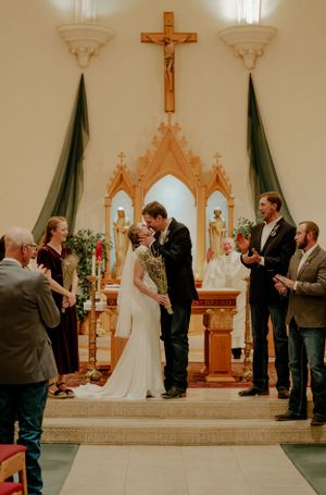 A couples first kiss in the front of a church