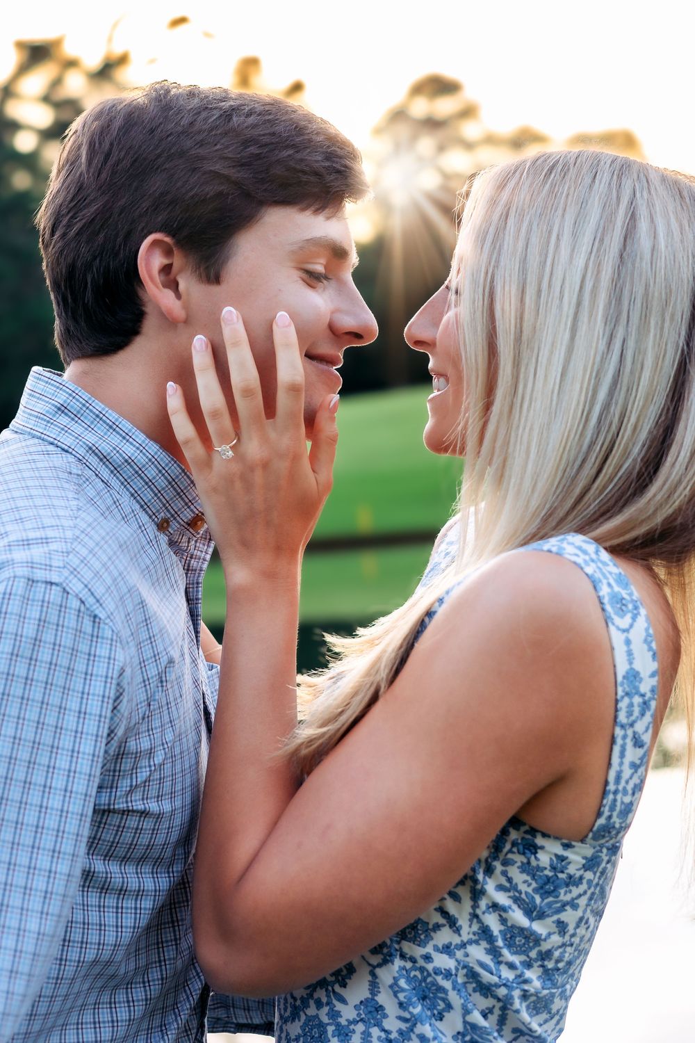 Could smiles facing each other with sunset shining behind them showing off her new engagement ring Athens Country Club during after proposal