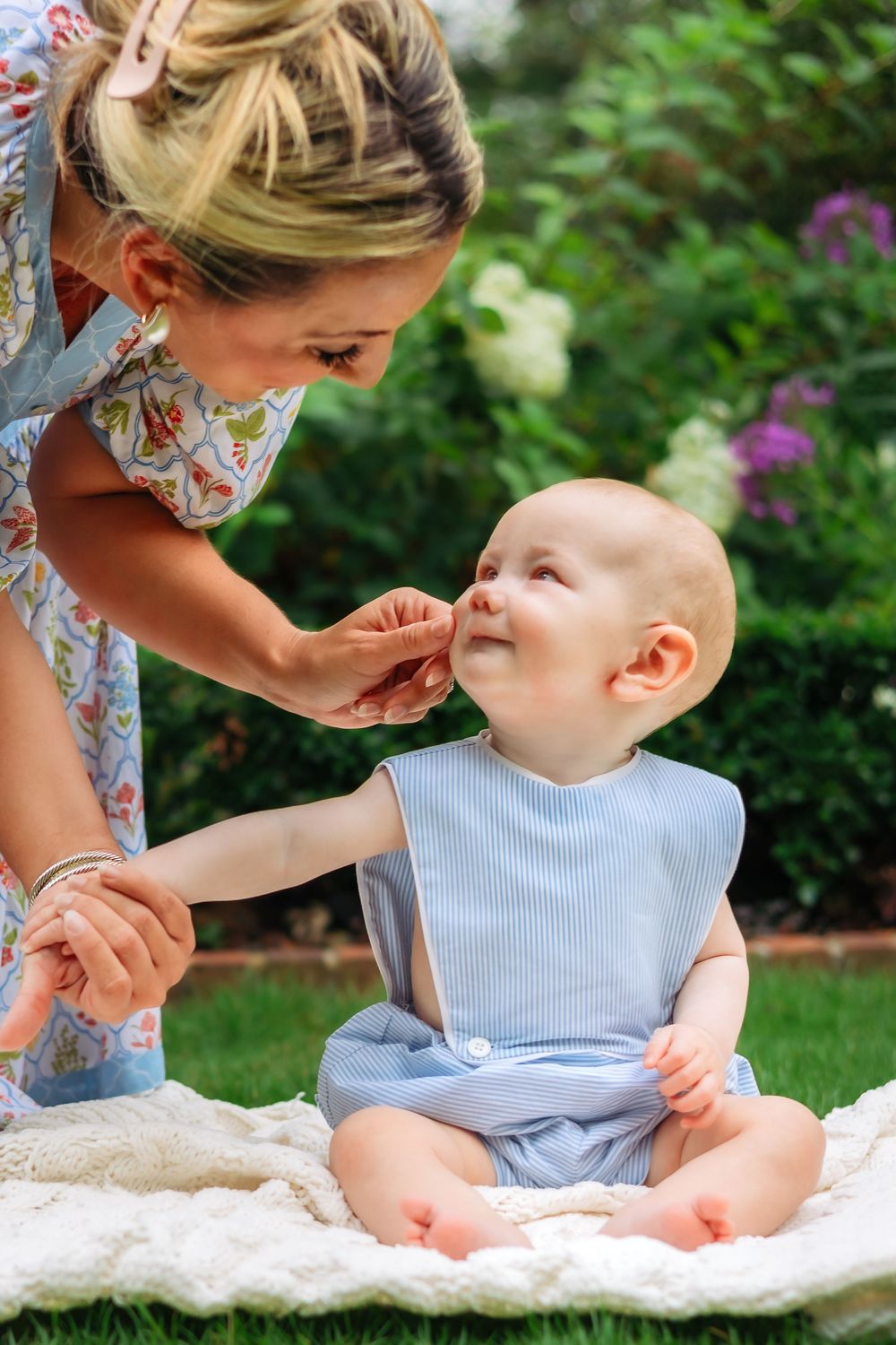 Mom touches baby boy's cheek during his milestone session at UGA Founders Garden in Athens GA