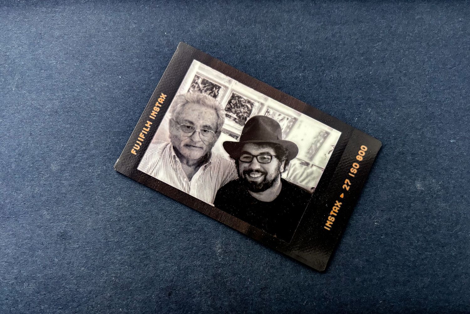 A vintage black and white polaroid photograph displayed on a dark surface.