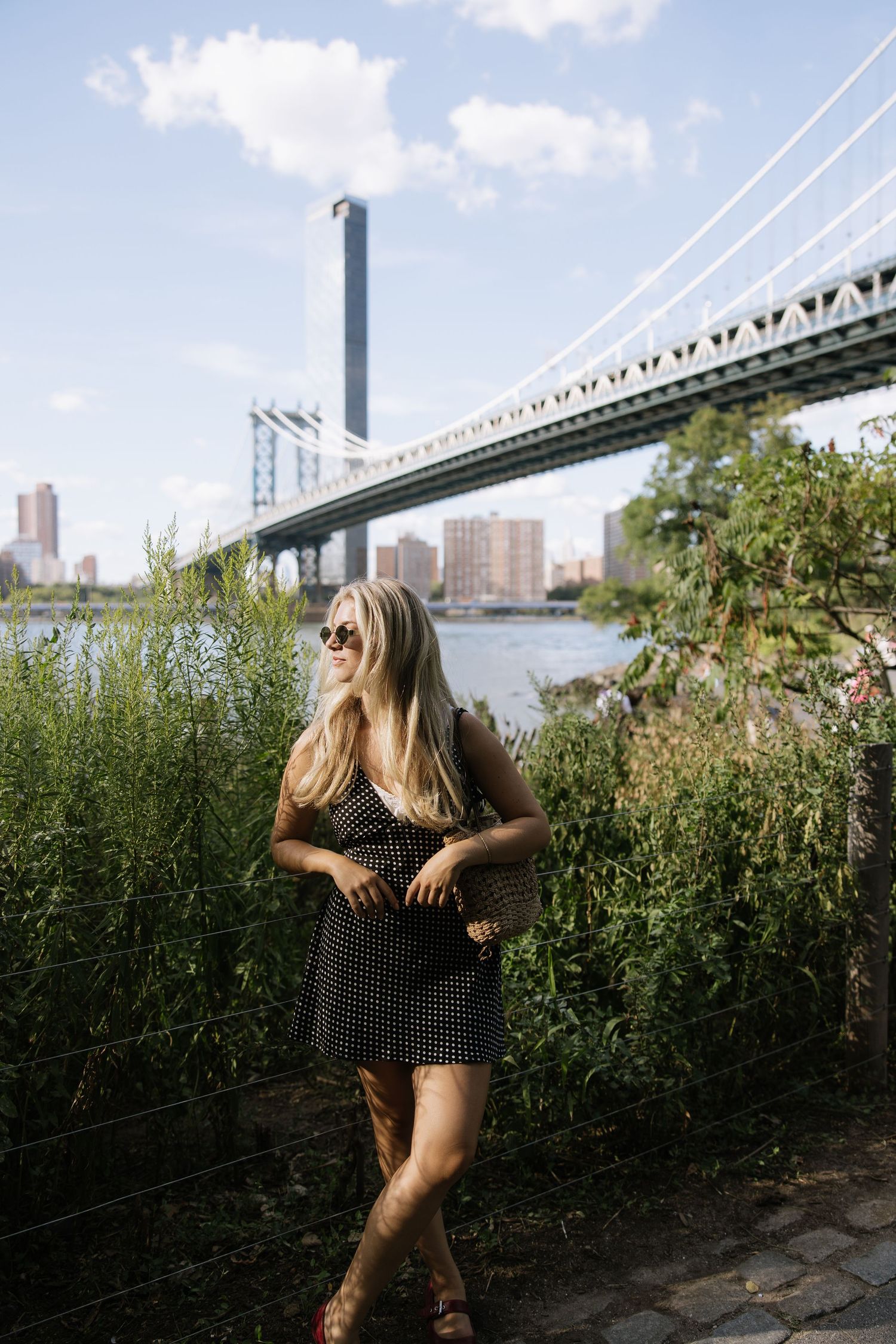 Photographer posed for head shot in front of the Brooklyn Bridge in New York