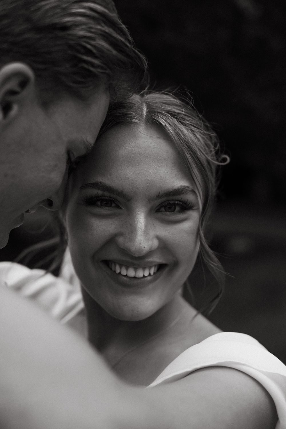 bride resting her head against groom's forehead looking into camera while being captured by wedding photographer in Uppsala