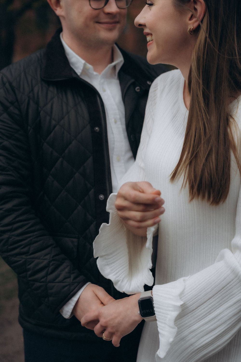 Close-up of an engaged couple holding hands during an urban engagement session in Helsinki city centre