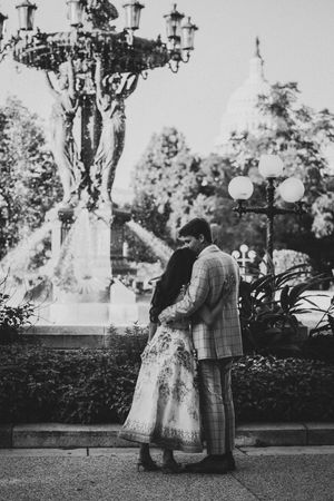 Couple walking hand in hand through Bartholdi Gardens after saying yes