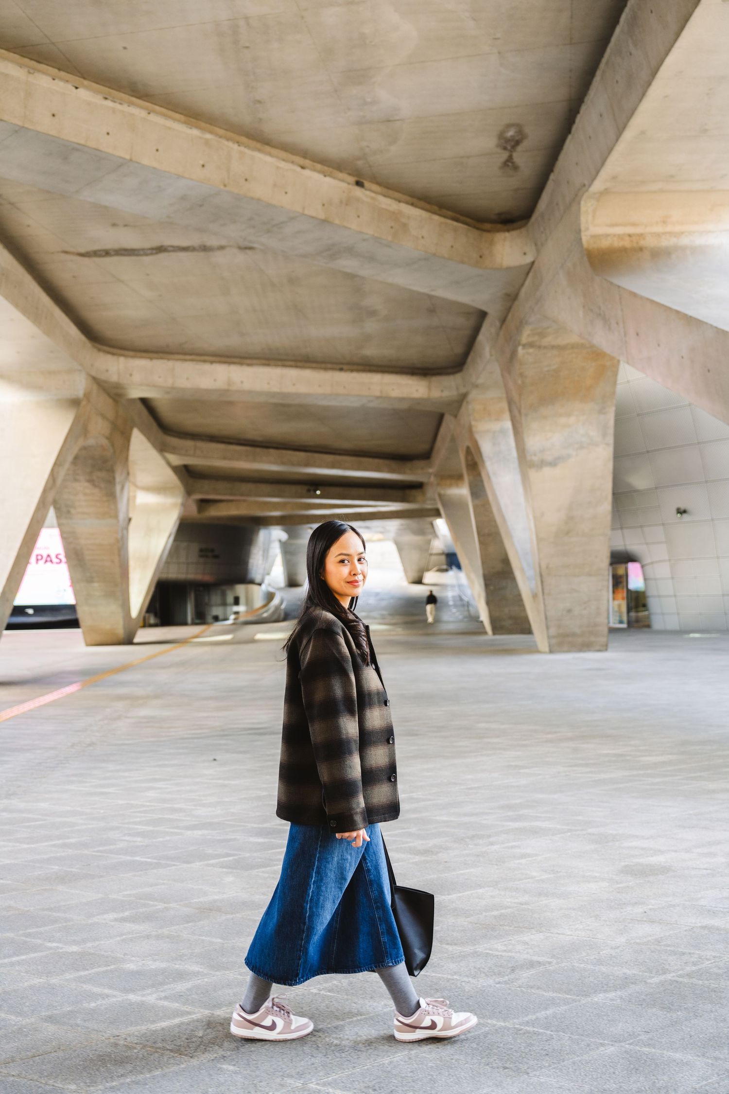 A sequence of photos showing a person walking through an angular concrete parking structure with dramatic lighting.