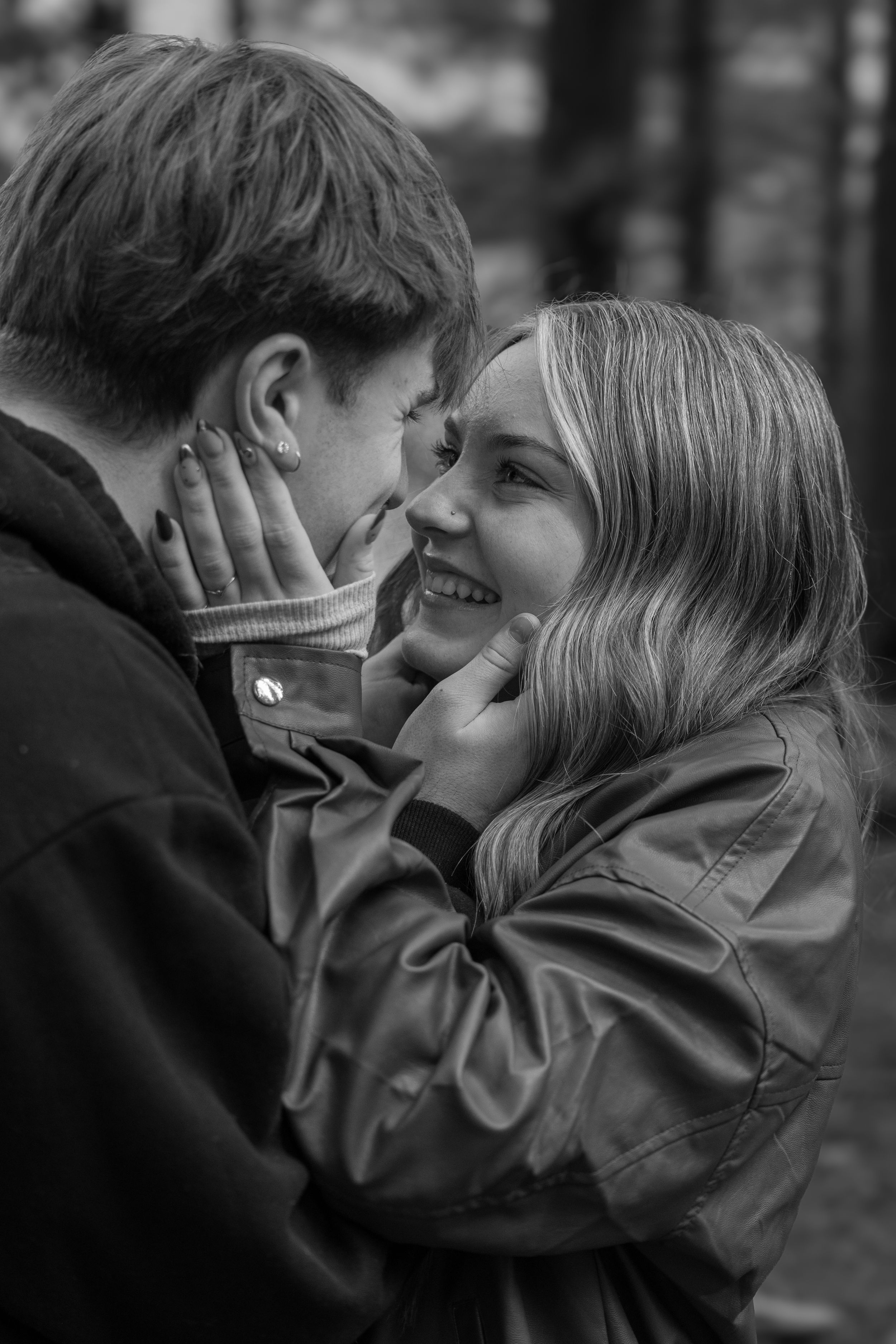 A romantic black and white photo sequence showing a couple sharing tender moments and kisses.