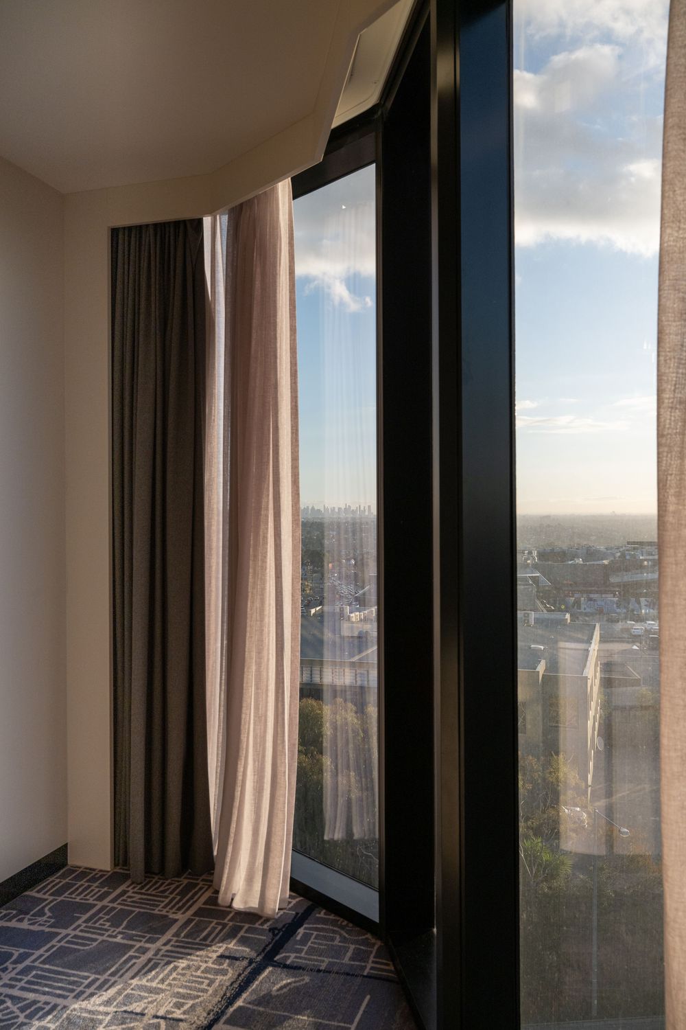 Hotel accommodation photography featuring floor-to-ceiling windows and Melbourne skyline views