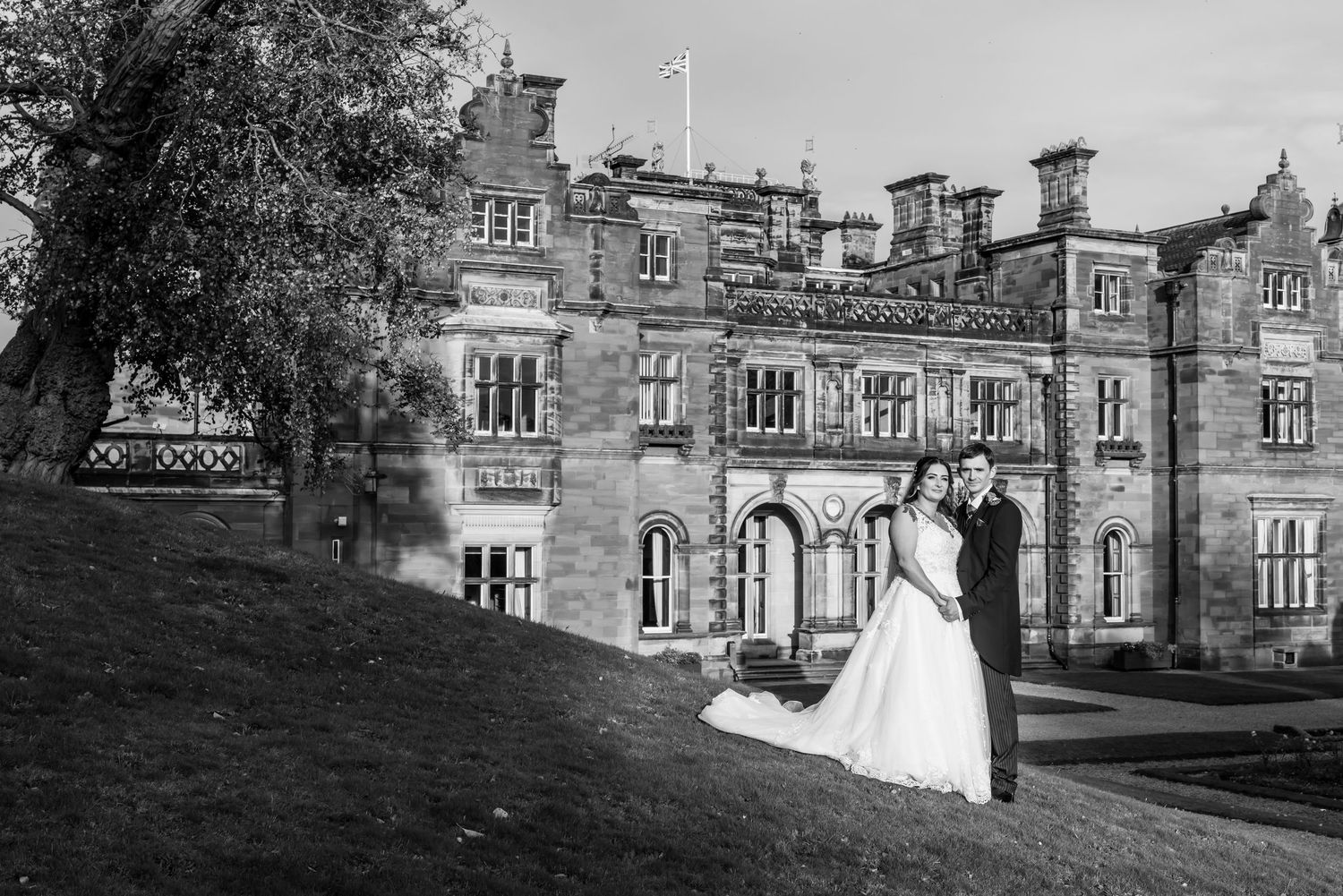 Historic stone manor house with gothic architectural features photographed from multiple exterior angles.