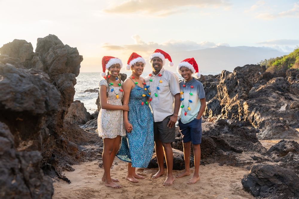 Maui family photo by ohwowfotos during sunset beach in Hawaii with Christmas hats theme