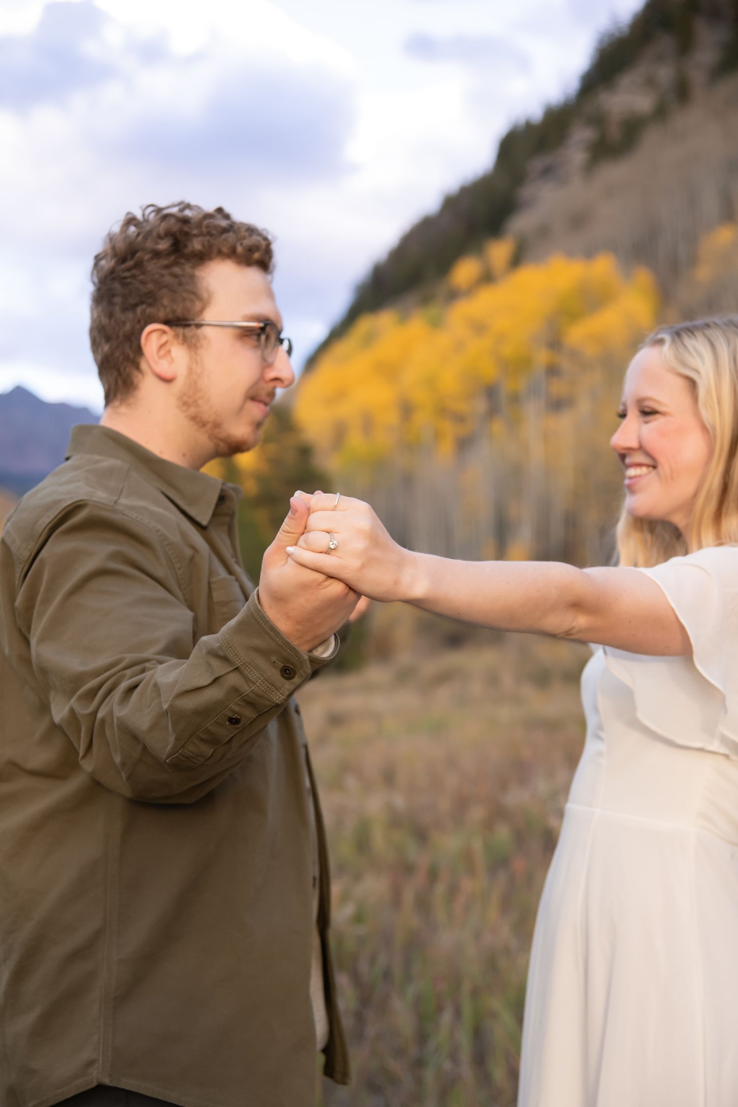 candid engagement photos in Vail Colorado with a cute couple dancing in the Colorado fall foliage