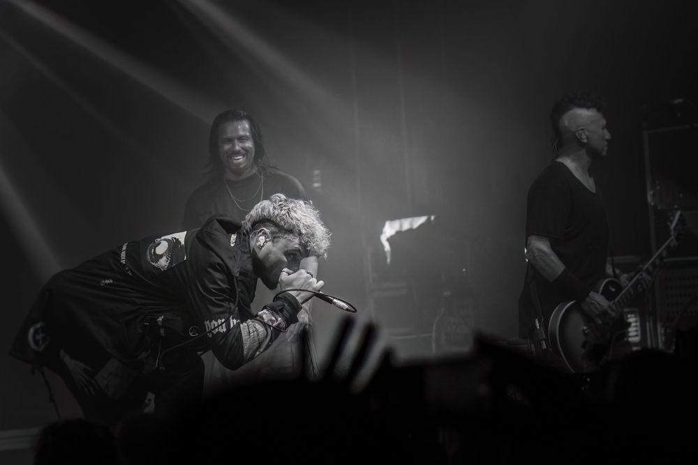 Black and white concert photos show performers on stage with dramatic lighting and energetic performances.