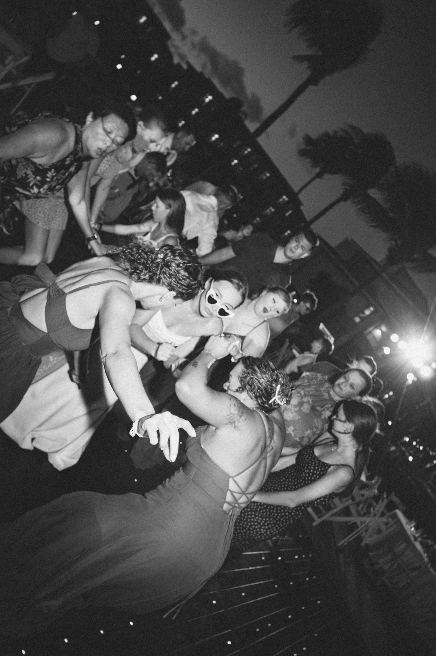 Black and white photos show a crowded concert scene with people dancing and moshing at a punk or rock show.