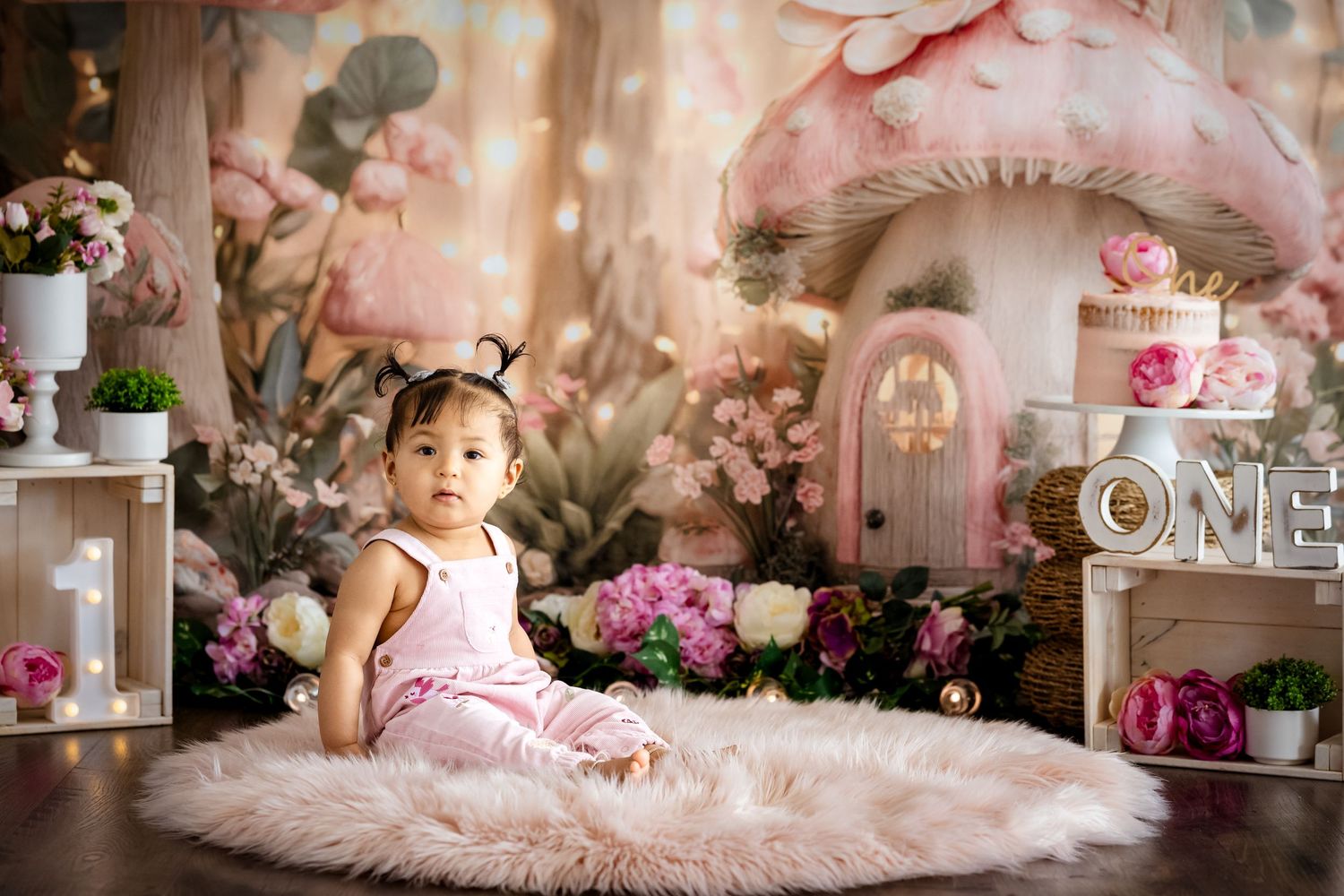A dreamy pink floral cake smash theme with romantic lighting and whimsical decorative elements. Suitable for Smash & Splash session.