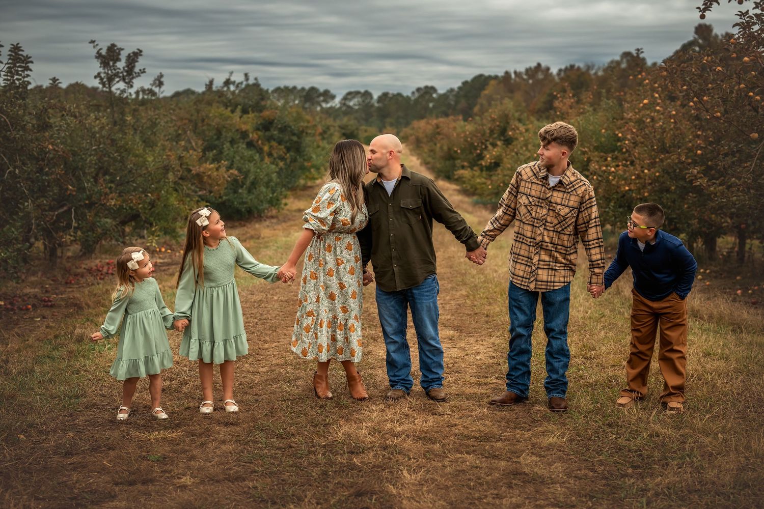 A series of family photos showing people holding hands and walking together in a rustic outdoor setting at sunset.