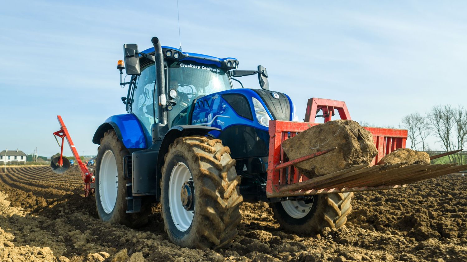 New Holland T7.210 pulling up potato beds