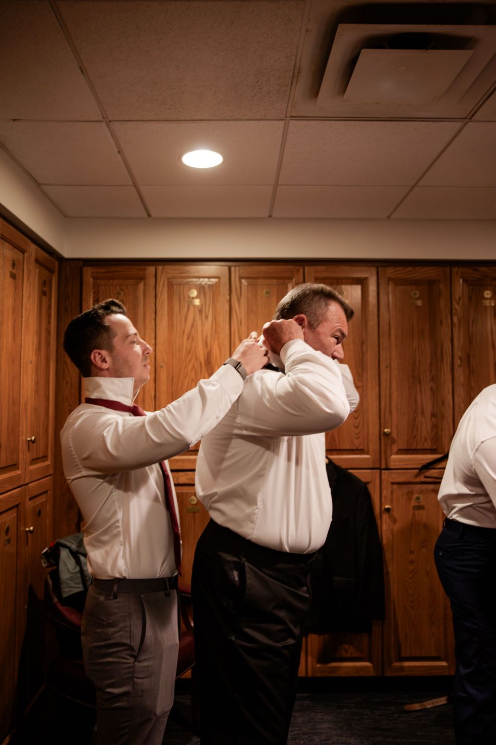 A series of photos showing groomsmen getting ready in formal attire against wood paneled walls.