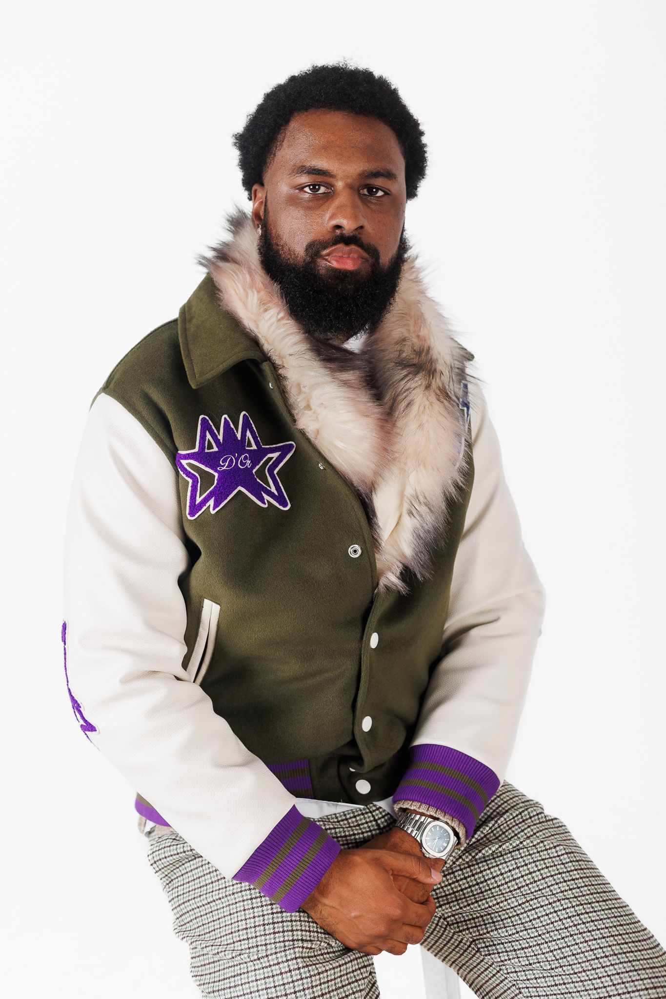Fashion model wearing olive green vest with fur collar and white sleeves poses in three similar shots against white backdrop.