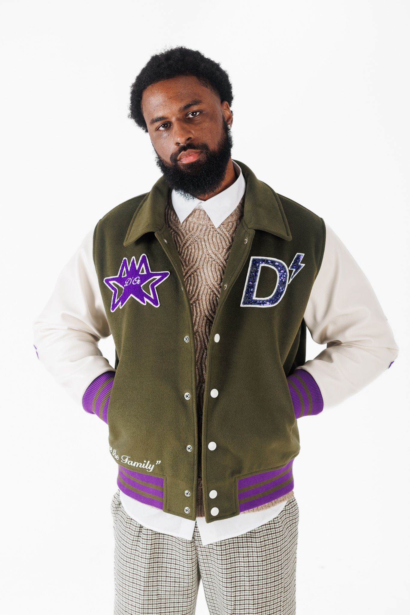 Athletic varsity jacket in olive green and purple with white sleeves shown from multiple angles.