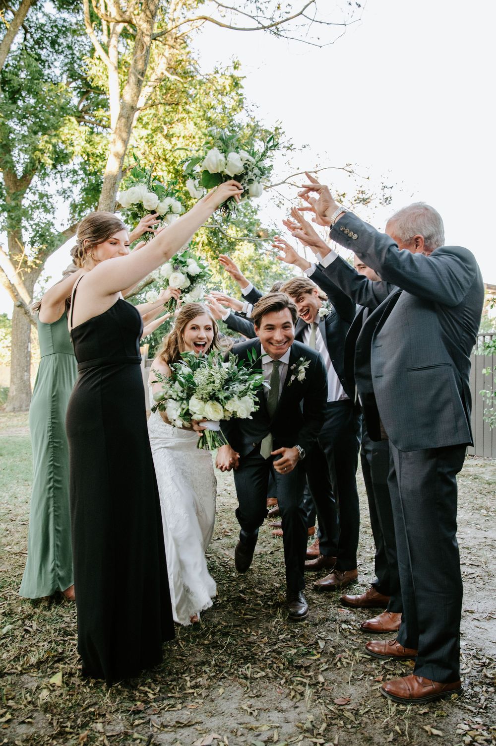 Wedding party celebrates outdoors with joyful poses under trees in a candid photo sequence.