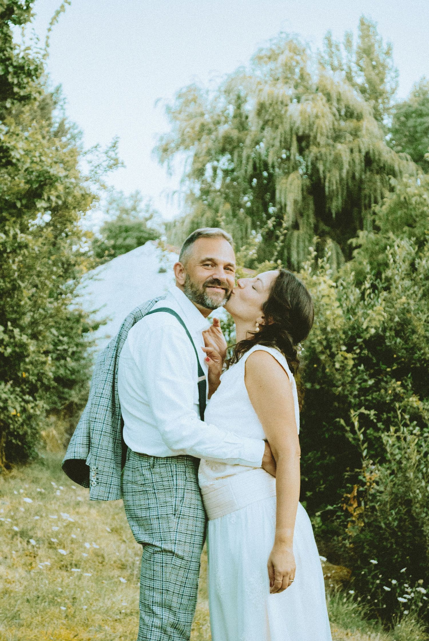 London engagement portrait featuring a couple embracing in a natural garden setting.