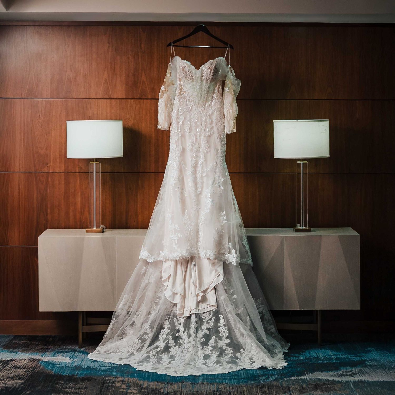 Bride’s lace wedding dress hanging during getting ready at the Westin Boston Seaport on a Boston wedding day