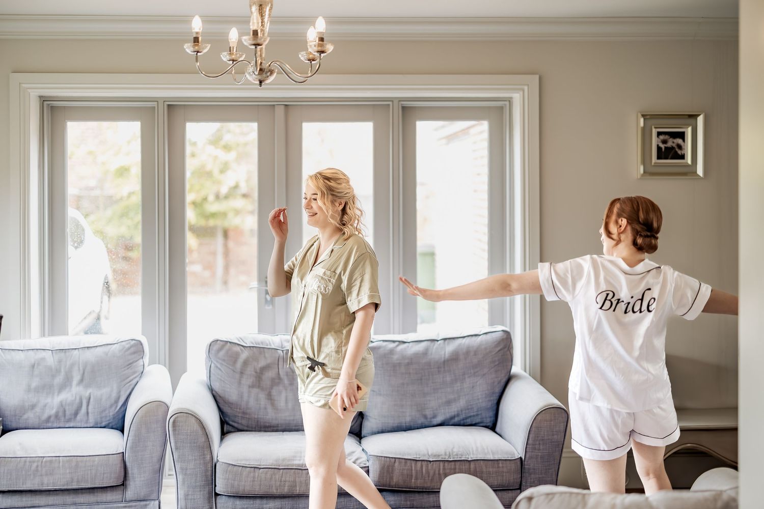 Natural fun moment between bride and bridesmaid during bridal prep on wedding day.