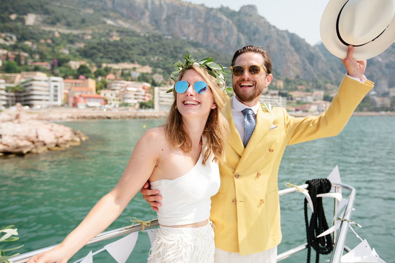 Bride and groom on a catamaran in the bay of Villefranche-sur-Mer during a French Riviera wedding