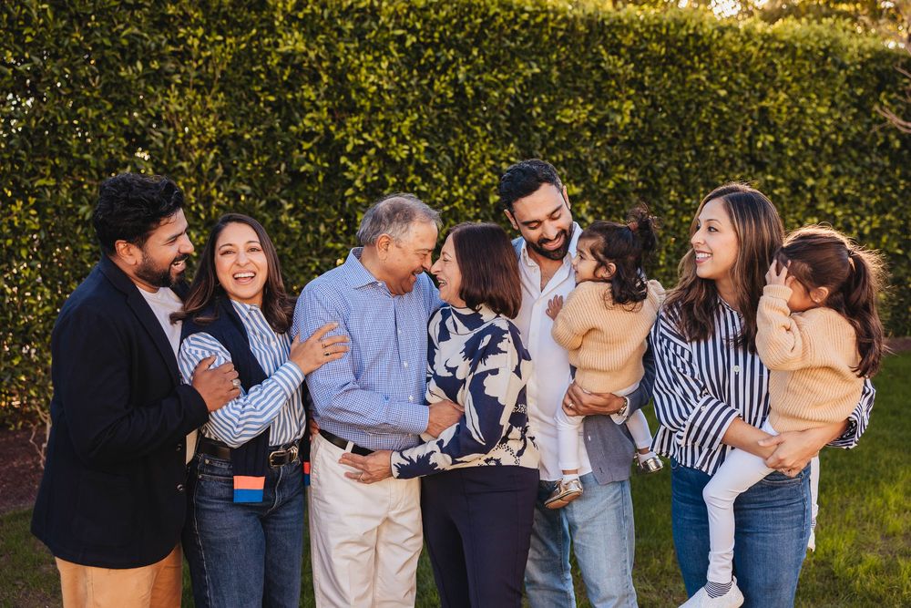 A series of candid outdoor family photos showing joyful moments and embraces in natural lighting.