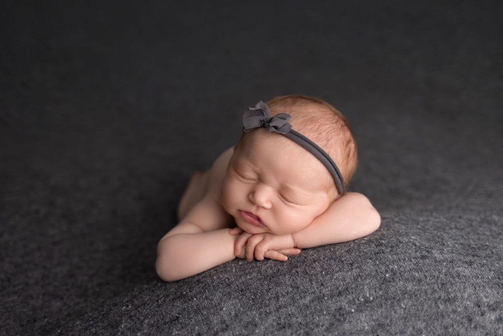 Newborn baby on grey background, taken by Jen Knightstep, Photographer