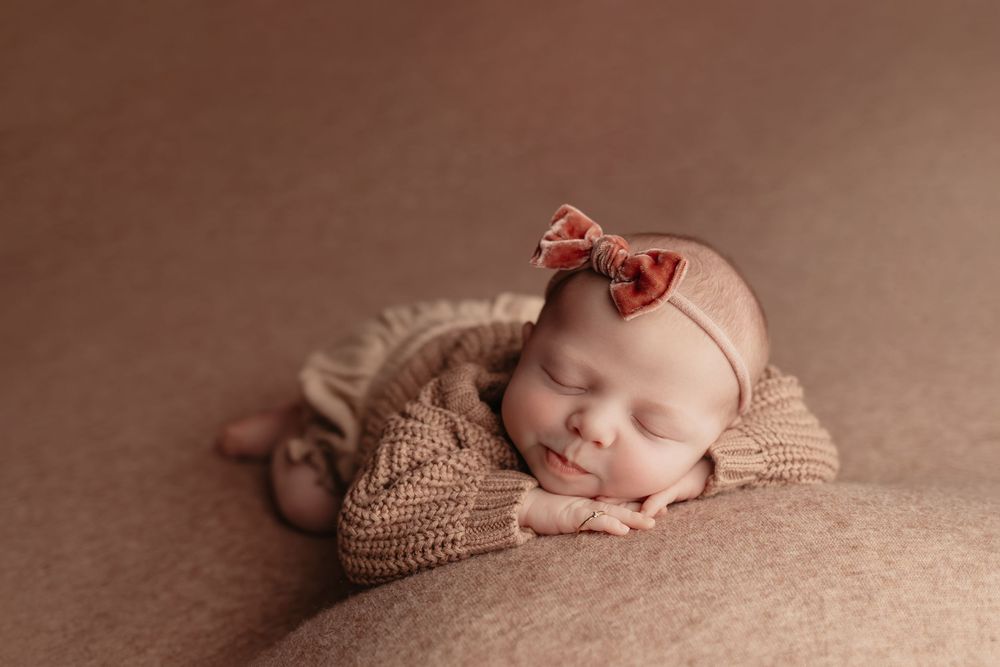 Newborn baby on pink background, taken by Jen Knightstep, Photographer