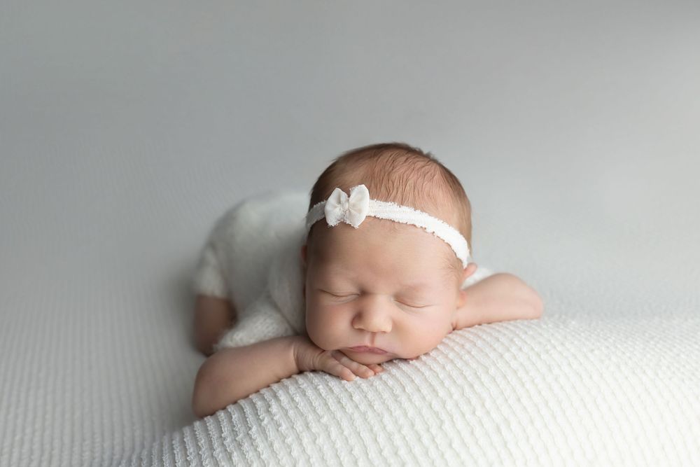 Newborn baby on white background, taken by Jen Knightstep, Photographer