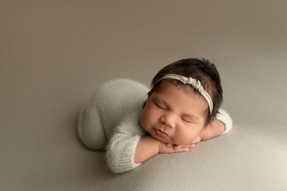 Newborn baby on pale green background, taken by Jen Knightstep, Photographer