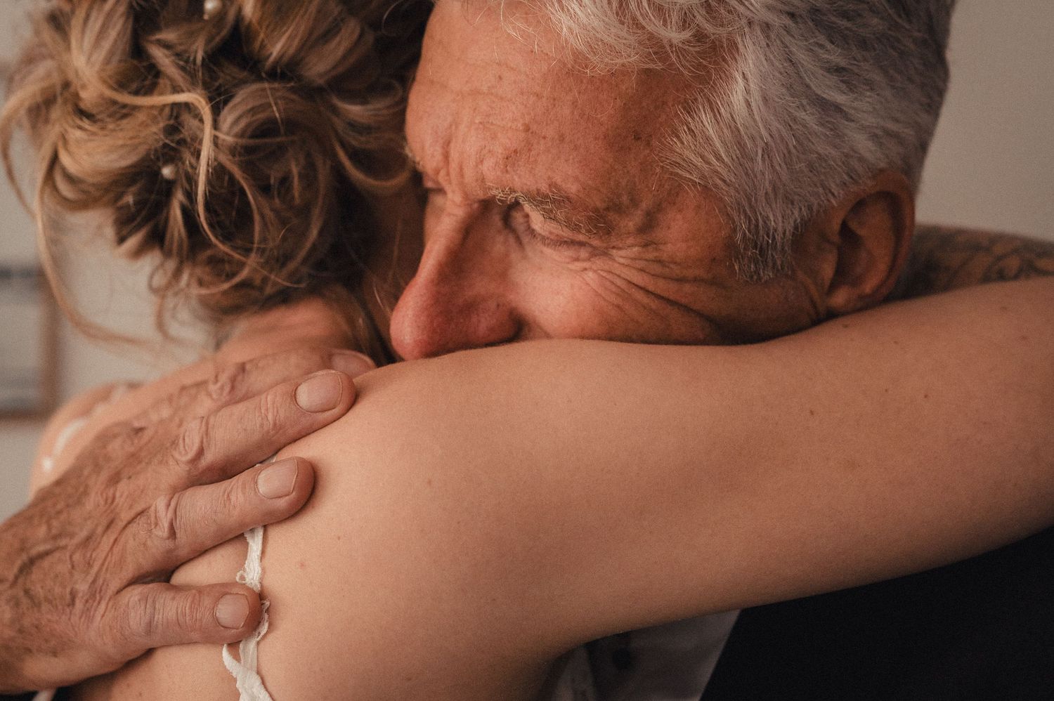 Elderly person and caregiver sharing tender moments of care and comfort through gentle embraces and hand holding.