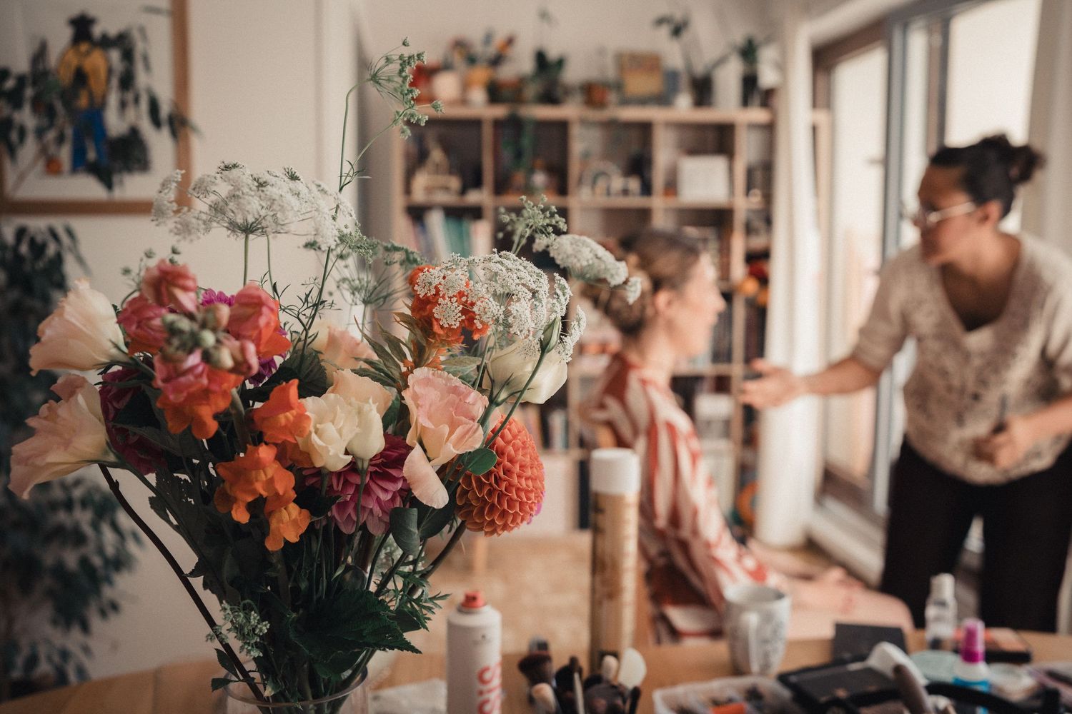 A collection of candid wedding celebration moments with flowers and decor in a rustic indoor venue.