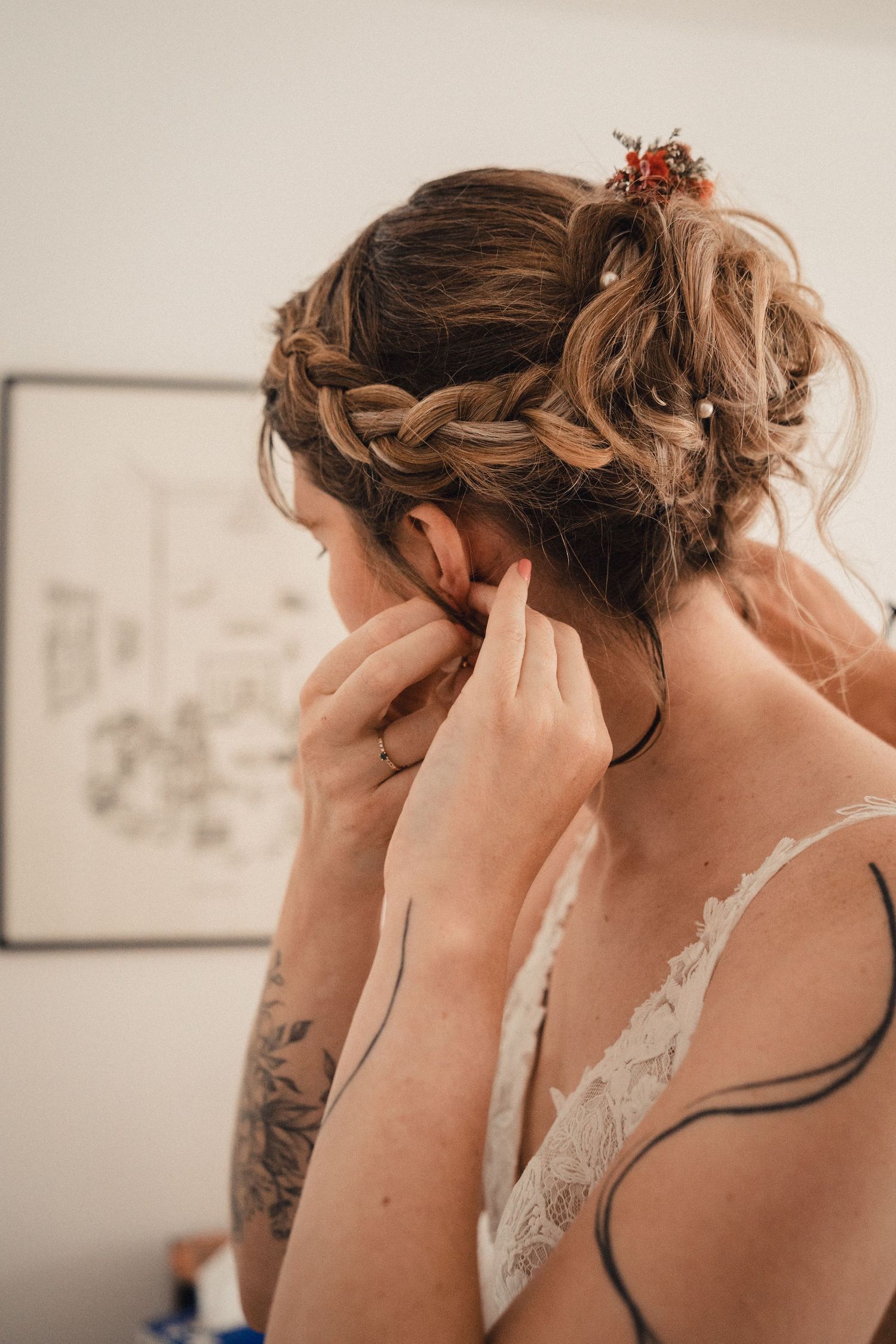 Close-up shots showing the styling of an elegant bridal updo hairstyle with soft waves.