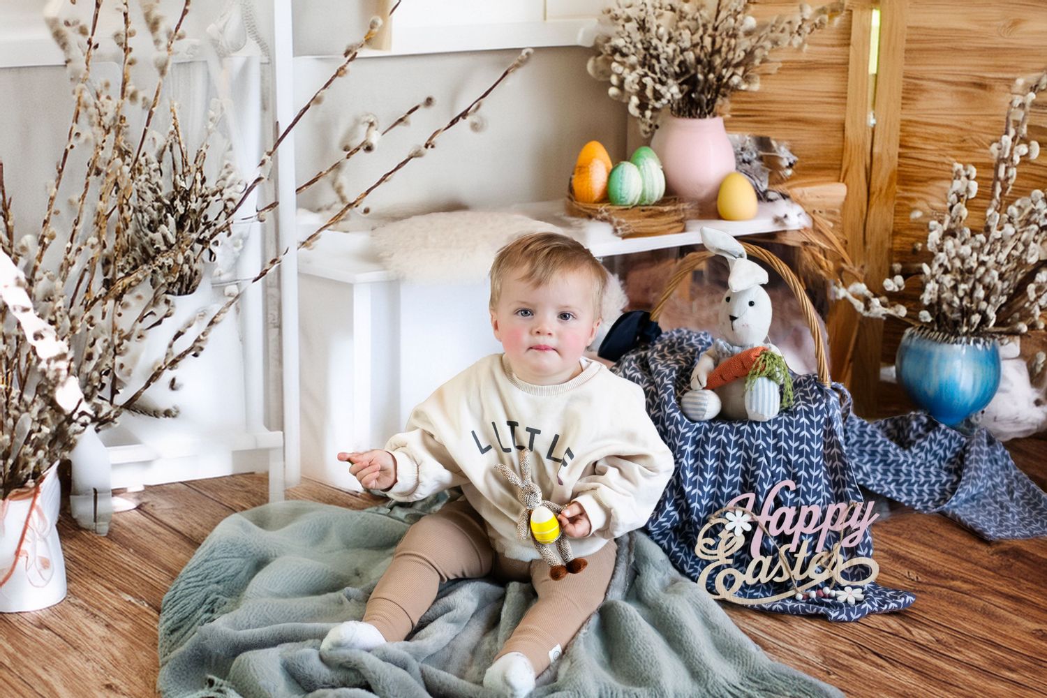 A spring photo session setup with cherry blossom branches and wooden decor in a bright interior setting.