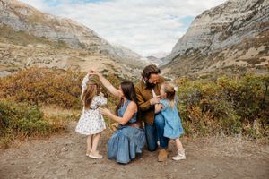 Scenic mountain landscape views with people enjoying outdoor moments along a rocky hiking trail.