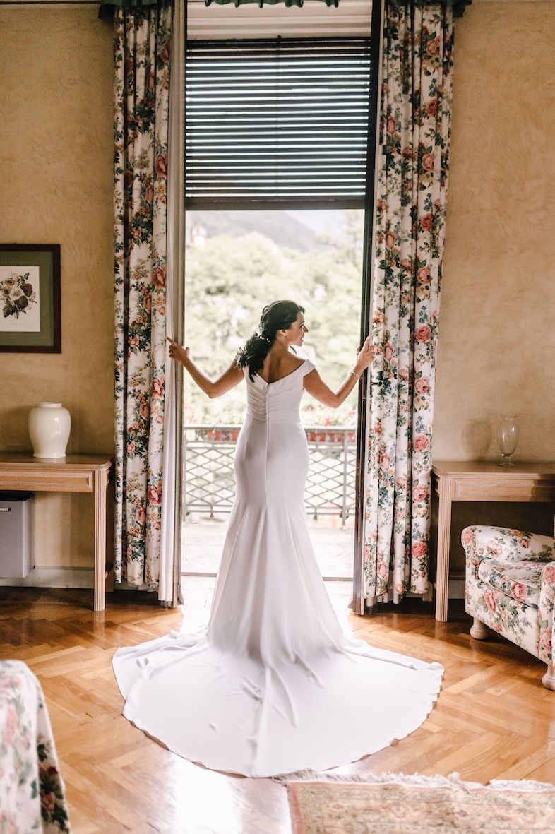 Bride getting ready in suite of historic villa overlooking Lake Iseo