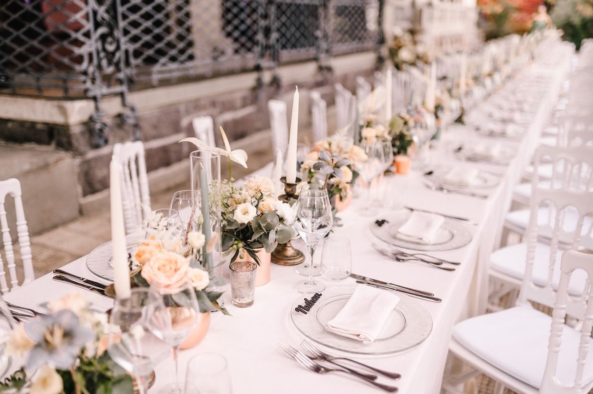 Long wedding dinner table under villa portico overlooking Lake Iseo