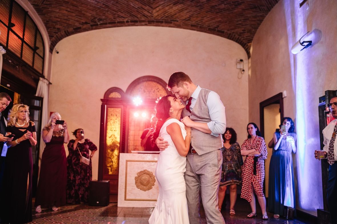 Bride and groom dancing during Lake Iseo destination wedding celebration inside villa