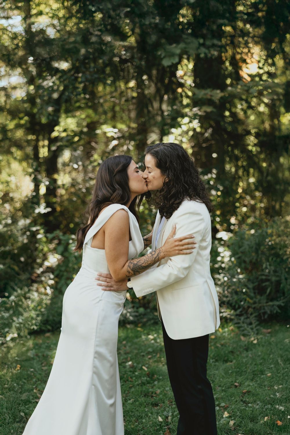 A romantic outdoor wedding sequence showing a couple in white embracing and sharing a tender moment in a garden setting.