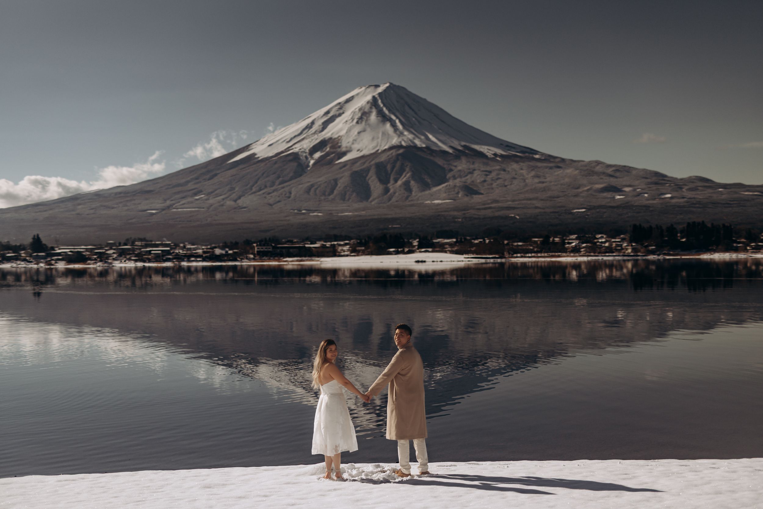 Scenic panoramic views of Mount Fuji reflected in Lake Yamanaka during different times of day and seasons.