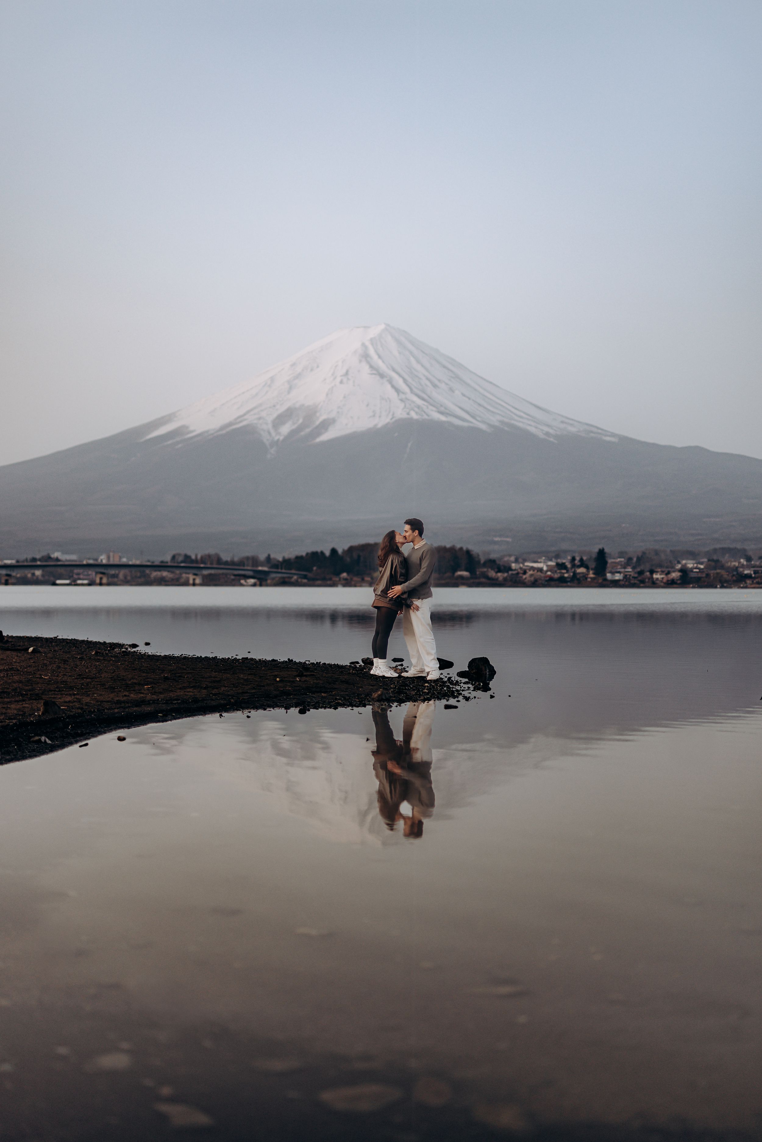 A series of photos showing Mount Fuji in Japan with silhouettes performing martial arts moves by the lake.