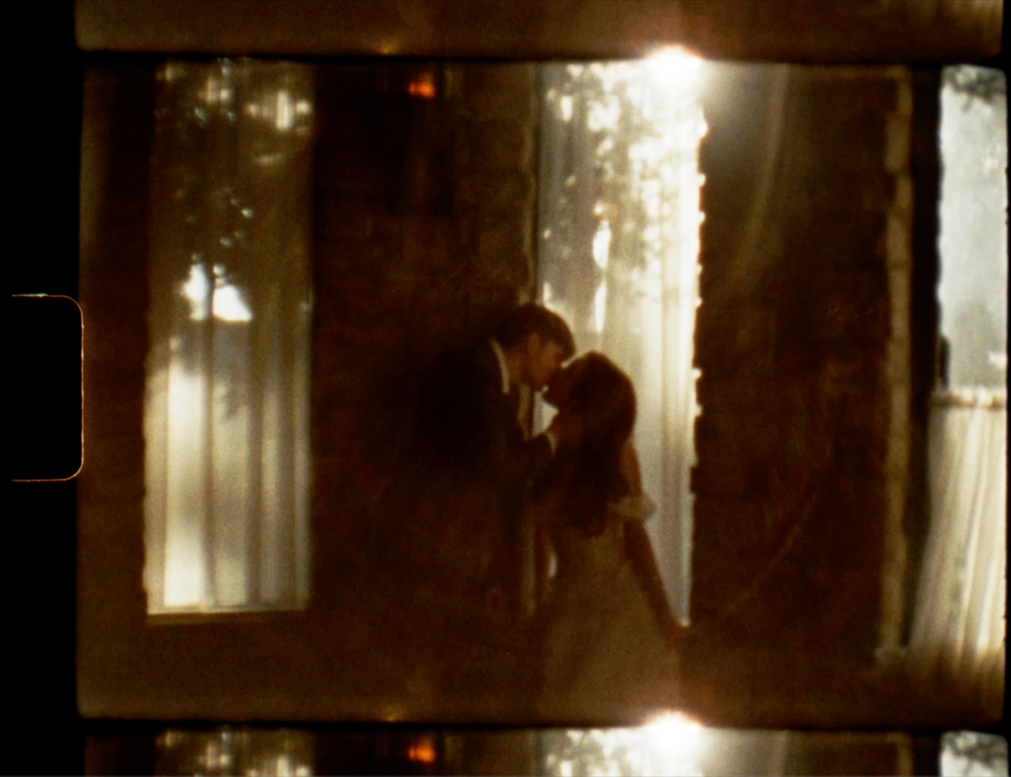 Dark silhouettes move through a misty forest with sunlight filtering through the trees creating an ethereal atmosphere.