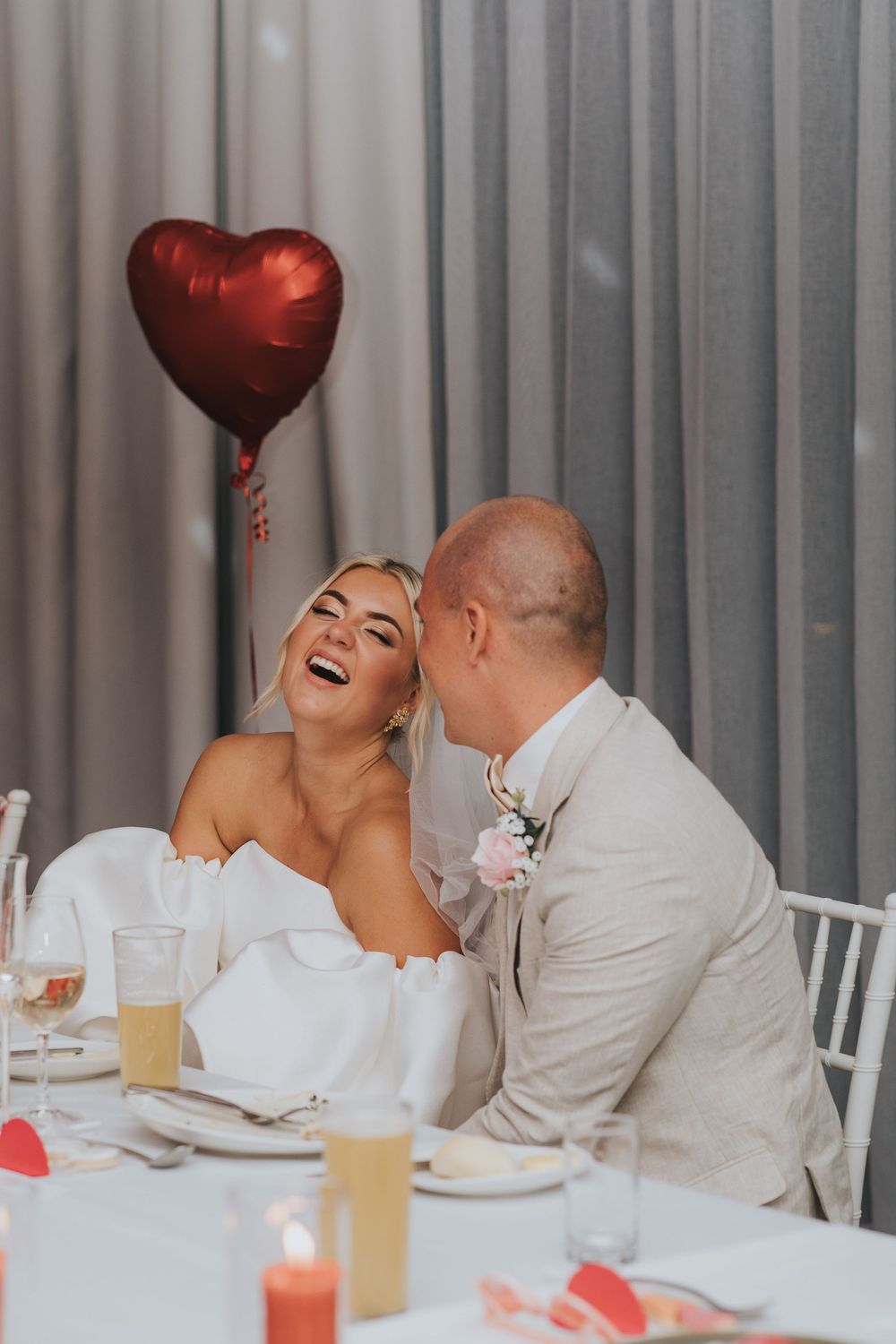 A romantic sequence of a couple laughing and sharing intimate moments at a white-tablecloth restaurant setting.