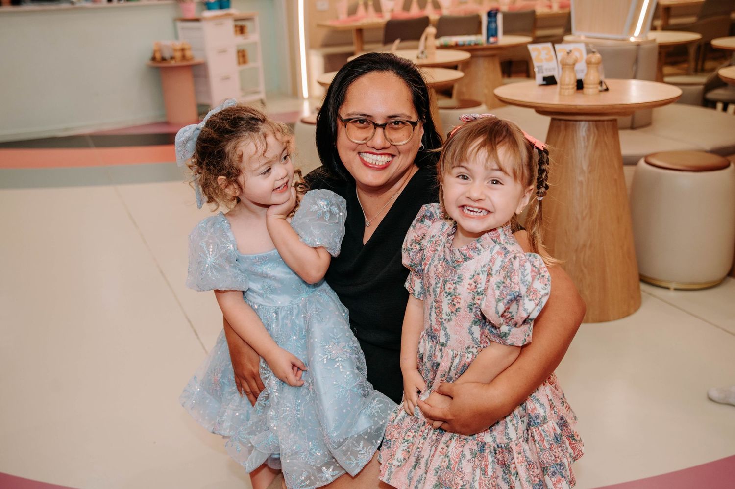 A daycare or school setting with children and caregiver sharing a happy moment together.