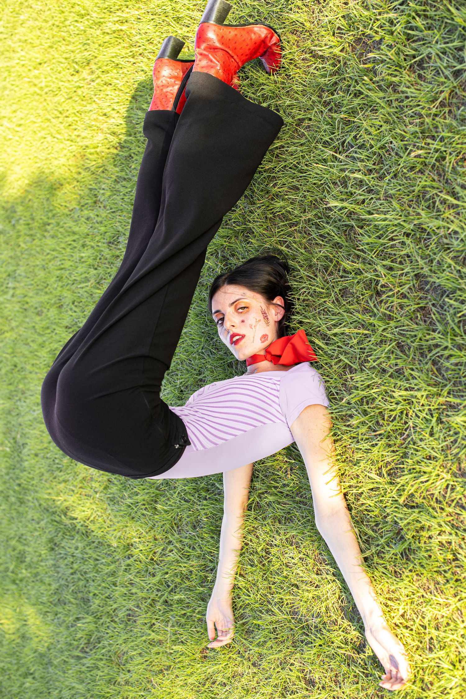 A portrait of a girl posing in the grass.
