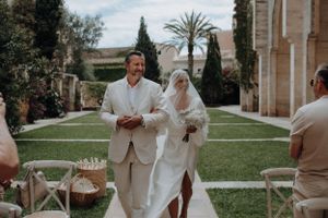 Bride and groom walking down the aisle at an elegant outdoor wedding ceremony.