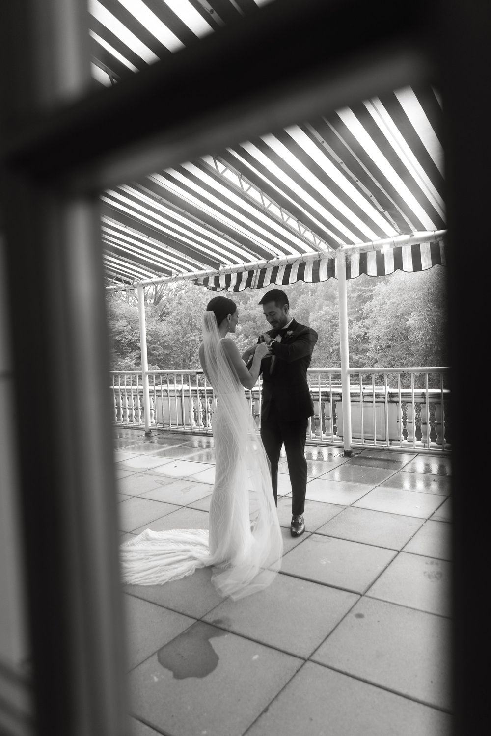 A black and white series showing a couple dancing on a covered patio with dramatic striped shadows.